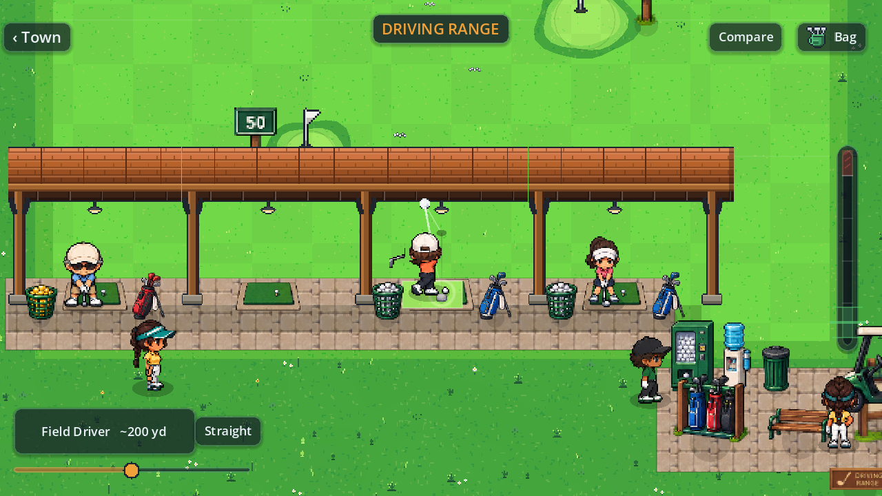 The covered driving range, golfers hitting from mats under a long timber shelter.