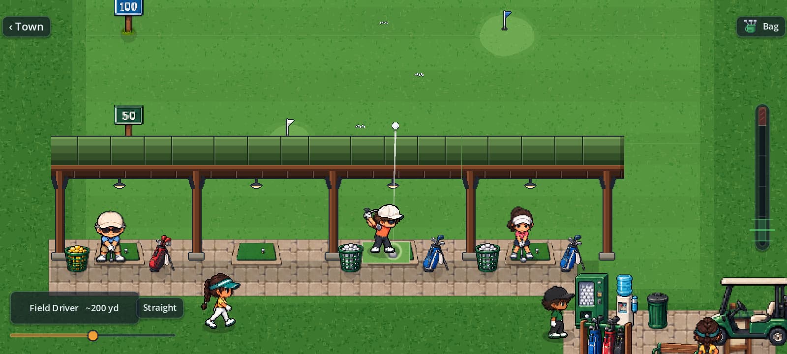 The golfer at impact in the middle range bay, the ball just leaving the mat.
